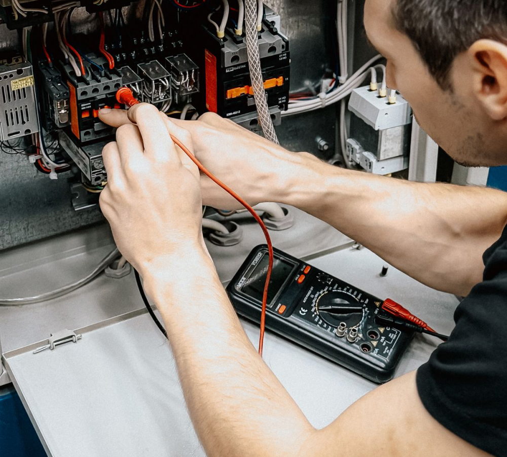 Electrician testing a switchboard